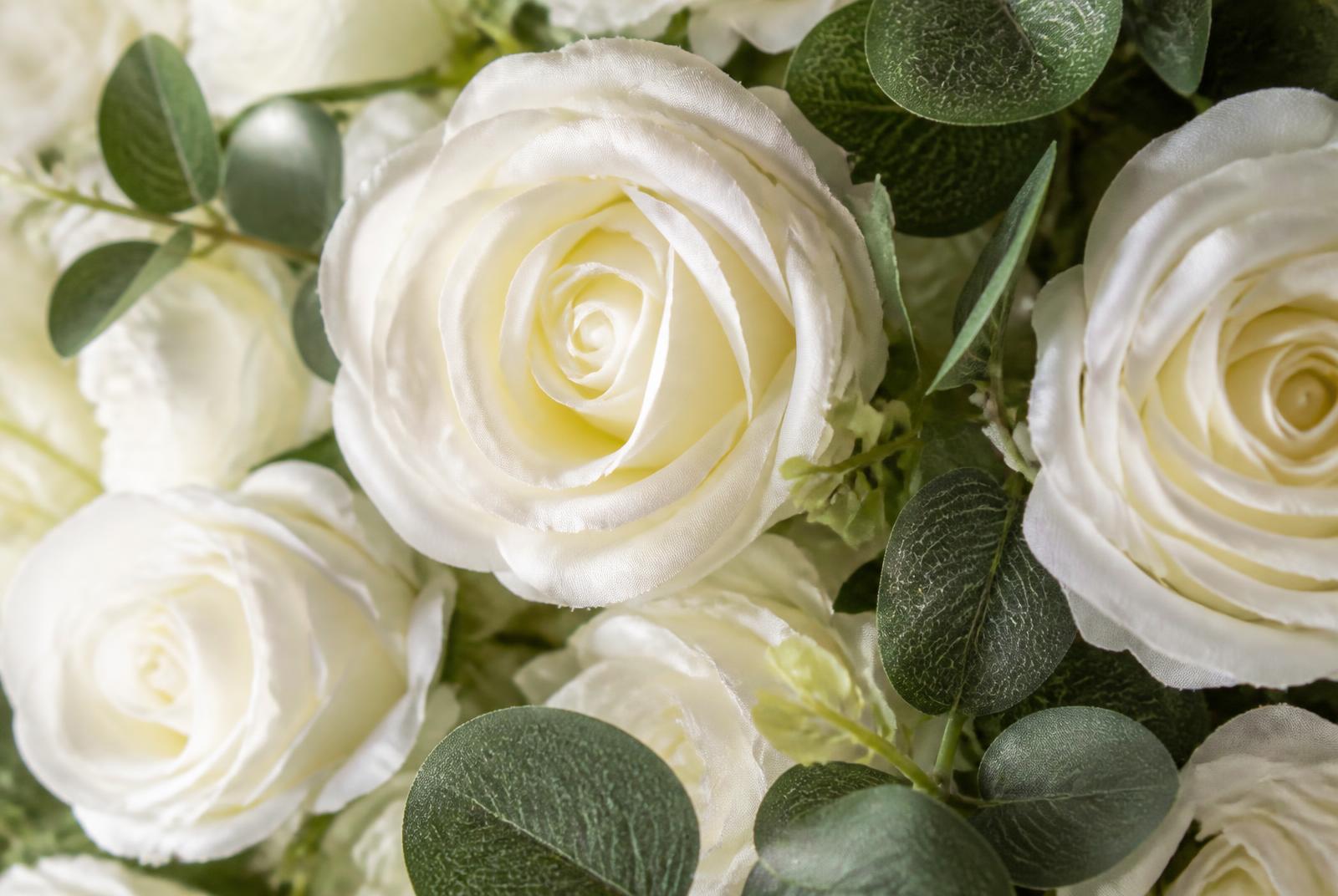 Close-up floral texture of white roses and eucalyptus on a flower wall